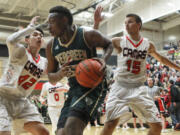 Evergreen High School player Robert Franks tries to control the ball as Camas High School players Kantas Zalpys (15) and Bryan Nguyen (42) surround him during Friday's 4A GSHL game at Camas.