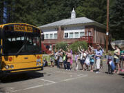 On the last day of the school year at Green Mountain School, staff members blow bubbles and wave goodbye to students on departing buses.