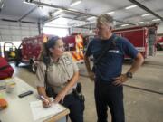 Clark County animal control officer Trisha Kraff collects information from firefighter Mike Hollingsworth about a kitten rescued Thursday from the electrical box of an RV.