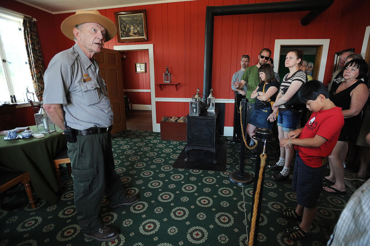 Don Hibbs, left, park guide at Fort Vancouver National Historic Site, leads a tour through the Chief Factor's House on Monday morning.