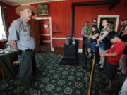 Don Hibbs, left, park guide at Fort Vancouver National Historic Site, leads a tour through the Chief Factor's House on Monday morning.