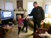 Lt. Steve Neal greets Lillie Killaby, 7, while delivering Thanksgiving food to her family. &quot;Do you arrest people?&quot; Killaby asked.