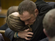 Photos by Ariane Kunze/The Columbian
Darrell Christopher Fry embraces friends and family after pleading guilty to manslaughter Thursday in connection to the shooting death of Matthew Clark in October 2012.