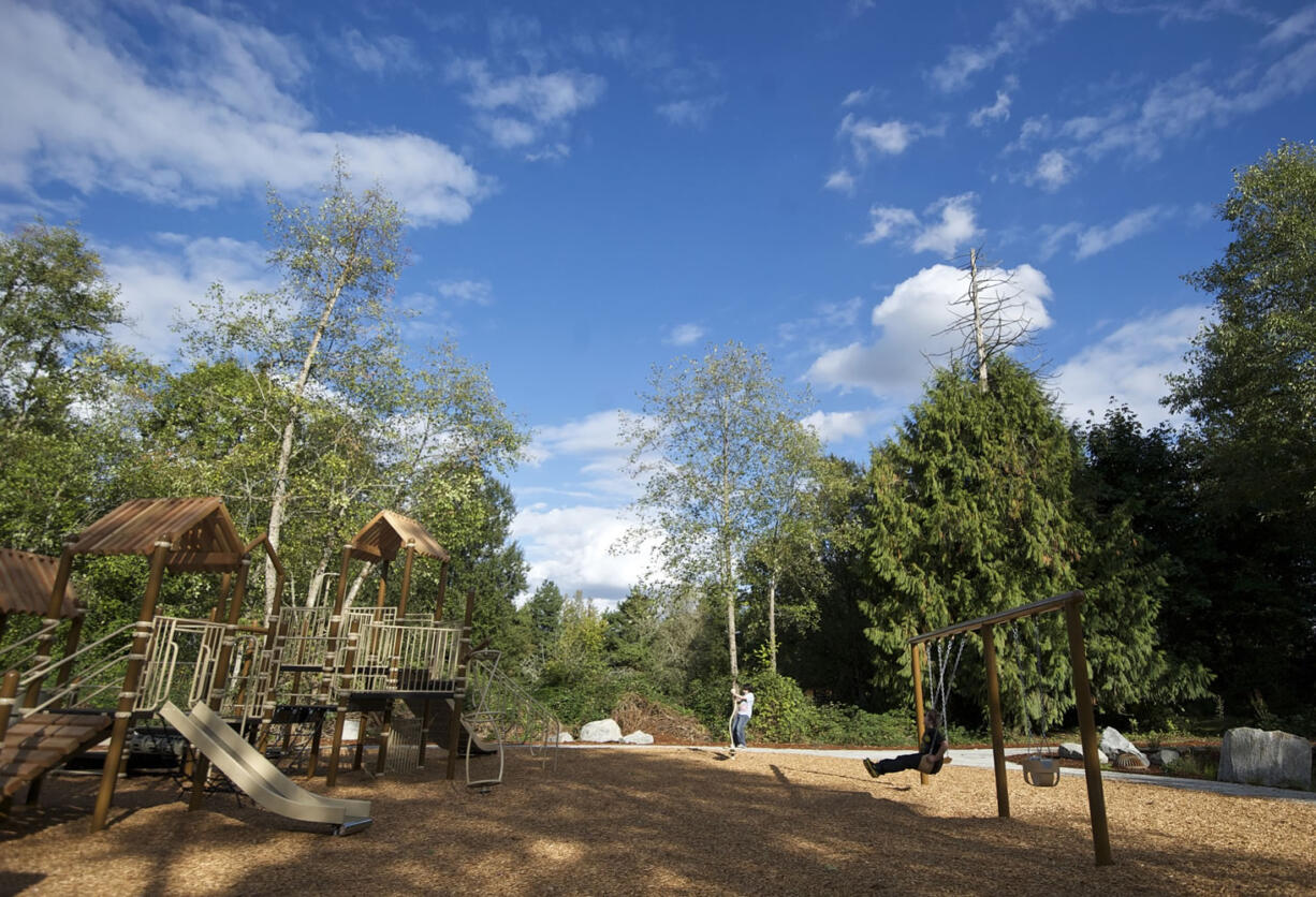 Two boys use the playground Friday at the newly built Chinook Neighborhood Park.