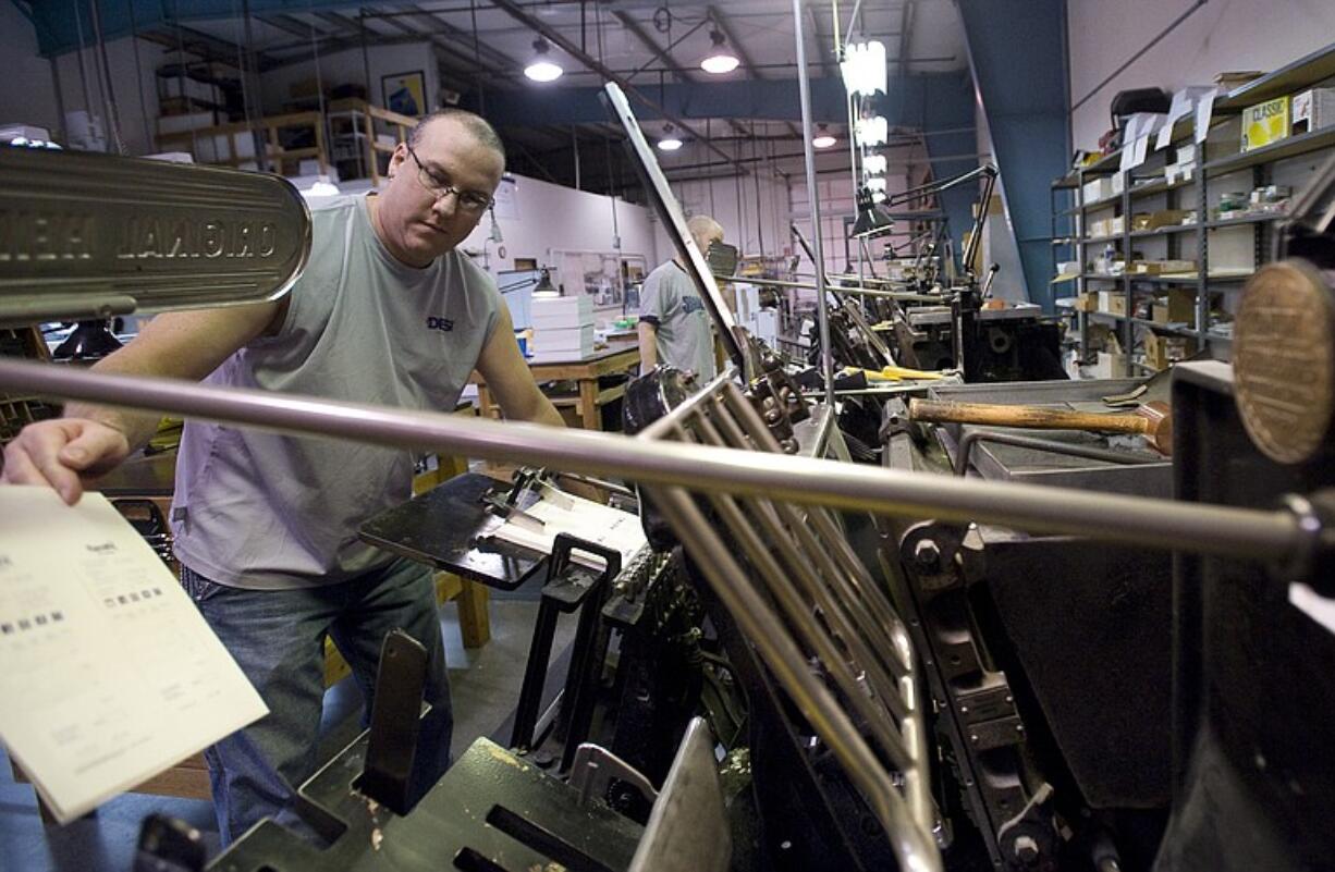 James Adair makes adjustments before running a job at DESIprint in Vancouver.