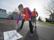 Kati Cooke, with her father Mike, stencils &quot;Dump No Waste&quot; near a Salmon Creek storm drain.