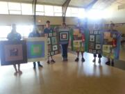 Fisher-Mill Plain: Members of the Holy Redeemer Catholic Church Youth Group hold quilts they made to give to migrant children during a mission trip to Bellingham.