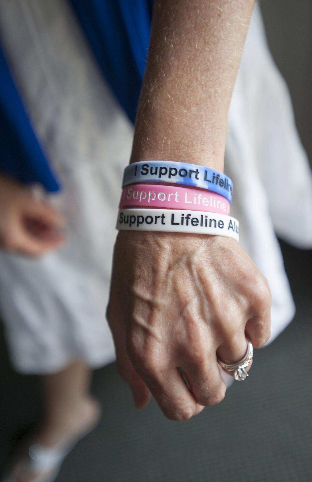 Shannon Edgel wears &quot;I support Lifeline&quot; bracelets.