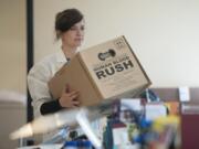 A technician carries a box designed to transport human blood during a Bloodworks Northwest community picnic and blood drive event on Sunday at the organization’s Vancouver donation center.