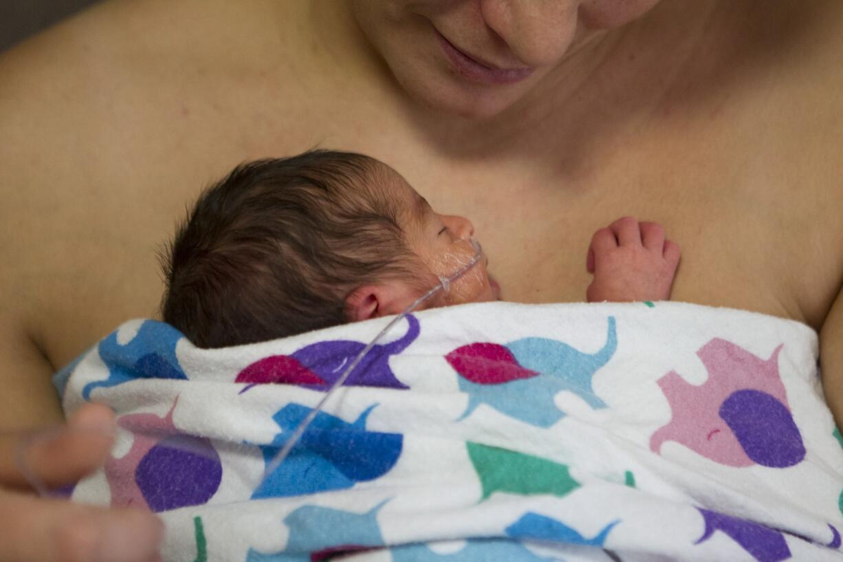 Louisa Escobar of Westport, Ore., practices kangaroo care with her newborn daughter Maria-Magdolena at Legacy Salmon Creek Medical Center in Vancouver.