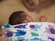 Louisa Escobar of Westport, Ore., practices kangaroo care with her newborn daughter Maria-Magdolena at Legacy Salmon Creek Medical Center in Vancouver.