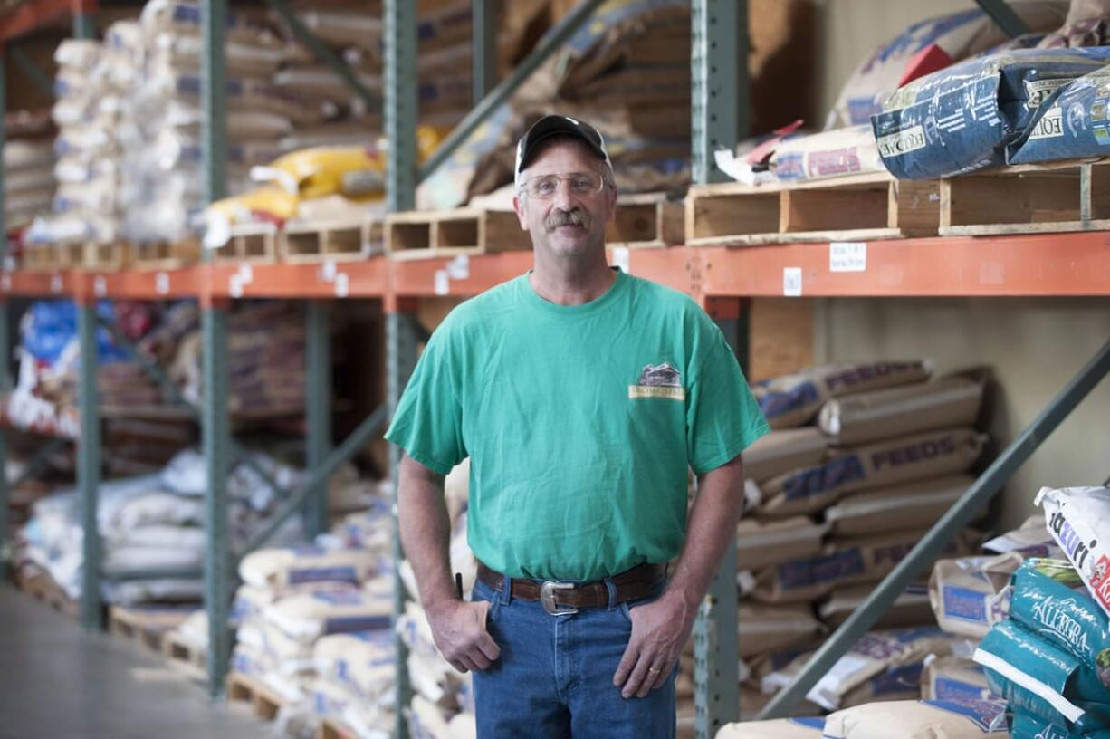 Tom Hughes, store manager at Orchards Feed Mill is seen, surrounded by feed products in Vancouver Wednesday August 26, 2015.