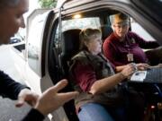 Sgt. Steve Dobbs with the Vancouver Police Department briefs NOW volunteers Rod Livengood and Janet Sword before going out on patrol.