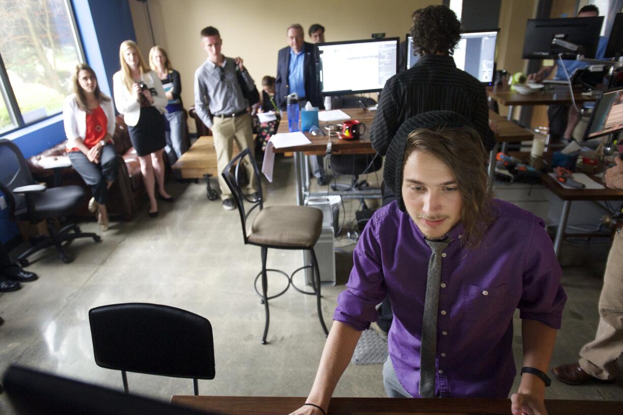 Washington State University Vancouver graduate Michael Langlois, an animator at Instructional Technologies shows U.S. Jaime Herrera Beutler, R-Camas, and students his work during a facility tour Tuesday.