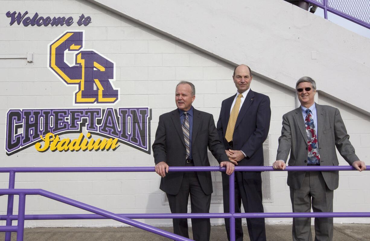 Clark County Sheriff Chuck Atkins, from left, Auditor Greg Kimsey and Treasurer Doug Lasher gather at Columbia River High School on Wednesday.