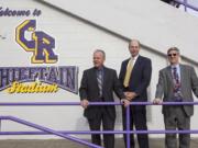 Clark County Sheriff Chuck Atkins, from left, Auditor Greg Kimsey and Treasurer Doug Lasher gather at Columbia River High School on Wednesday.