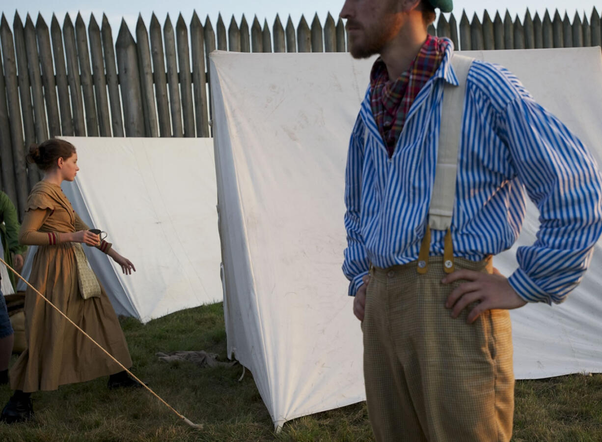 Amanda Josberger, 14, of Vancouver, enters a tent while showing visitors what life was like for a Fort Vancouver villager in the 1840s as part of the Campfires and Candlelight event at Fort Vancouver National Historic Site on Saturday.