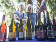 Leatha Tehennepe and Bill Hilleary pick out a wine at the Vancouver Wine and Jazz Festival at Esther Short Park in downtown Vancouver on Friday.