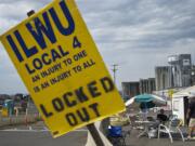 ILWU Local 4 members remain outside the United Grain terminal, on Tuesday, after word of a tentative agreement has surfaced.