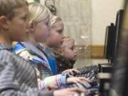 Homola siblings, from left: Jarett, 10; Janae, 8; Karly, 9, and Alexa, 6, practice math and reading skills on Jan.