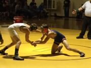 Ridgefield sophomore Trevor Newburn, right, wrestles against Jon McMillian of Hudson's Bay in the 113-pound 2A Region 3 final Saturday at Hudson's Bay.