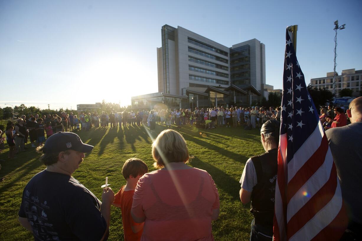 Supporters of wounded Vancouver police Officer Dustin Goudschaal gather Tuesday evening for a vigil in his honor at PeaceHealth Southwest Medical Center in Vancouver.