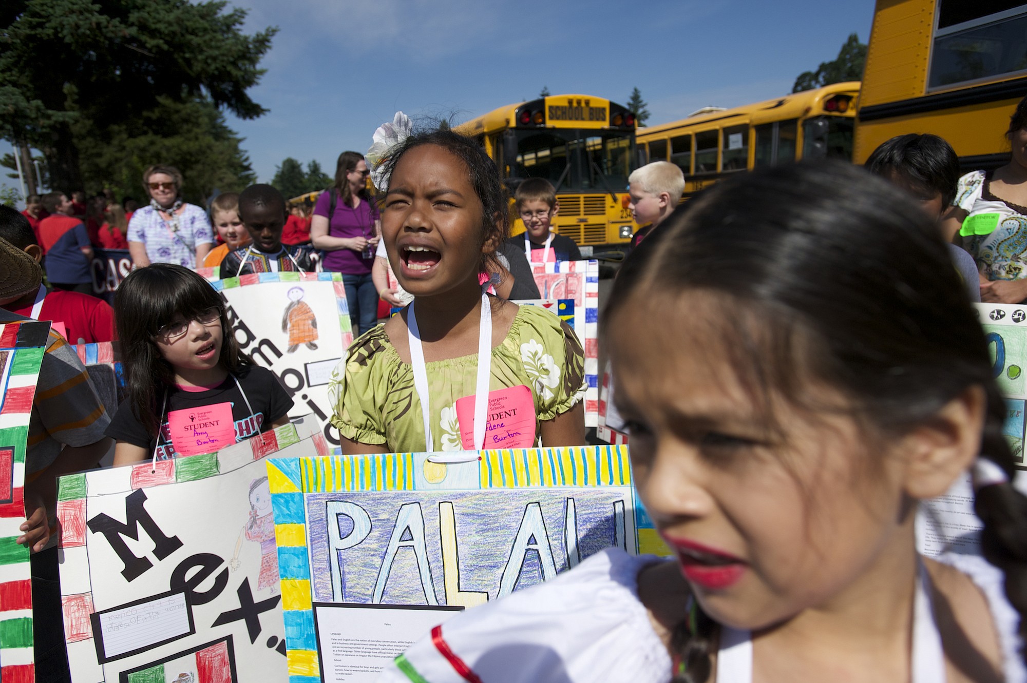 Third grader Edene Bilamang, center, gets warmed up with her Burton Elementary classmates before marching Friday in the Children's Cultural Parade.