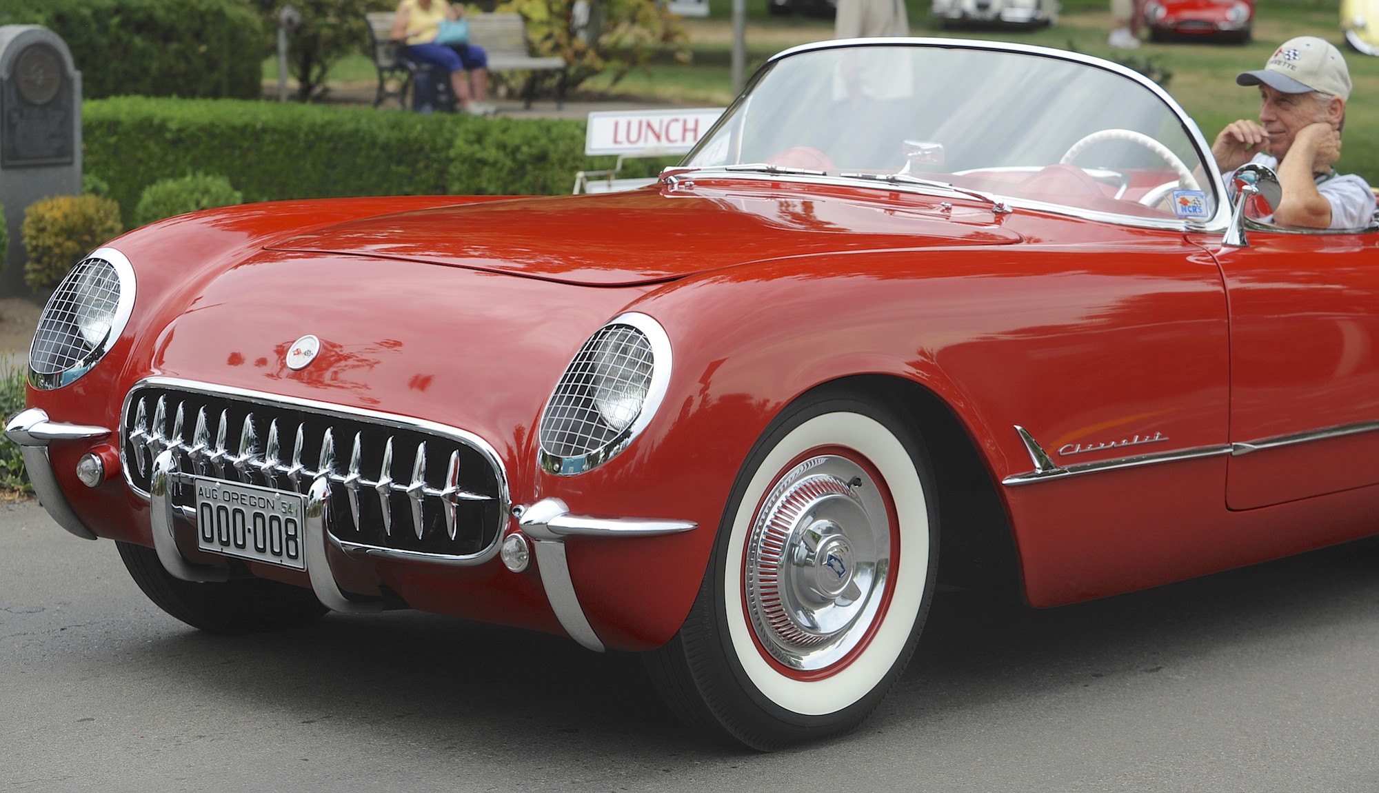 Emory Molchan, at right, sits in his 1954 Chevy Corvette at the 2015 Concourse d'Elegance at Officers Row in the Fort Vancouver historic site in Vancouver  Wa., Sunday August 2, 2015. He paid $100 for the two &quot;000 008&quot; license plates.