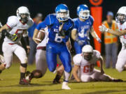 La Center quarterback Wyatt Aguirre breaks through the White Salmon defense for one of his two rushing touchdowns, part of the 356 rushing yards rolled up by the Wildcats.