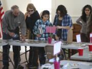 Local gardeners explore the wide range of seeds -- more than a million -- available Saturday at the first Great Clark County Seed Swap at the La Center Grange.