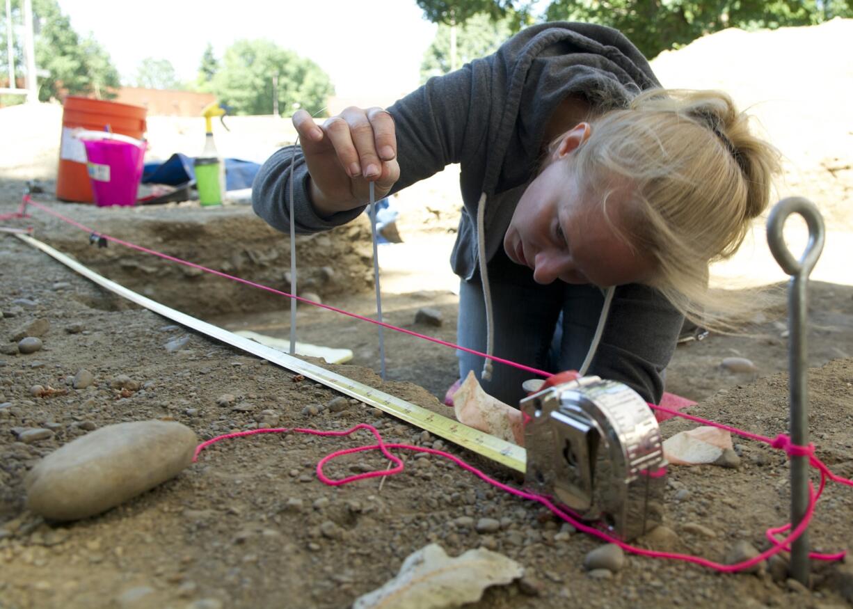 Photos by Paul Suarez/The Columbian
Jodi Marshall takes measurements to document where a wall stood at the Little Proulx dig at Fort Vancouver National Historic Site on Thursday.