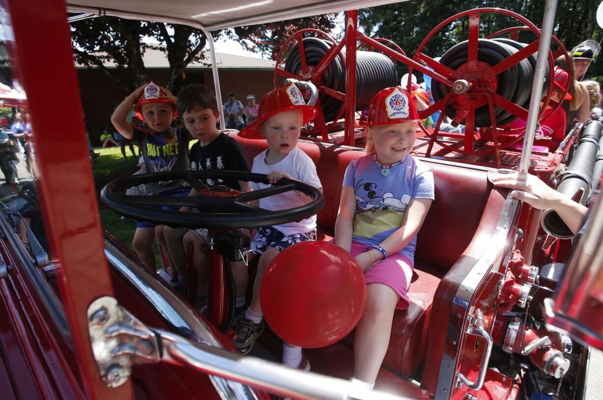 Photos by Steve Dipaola for the Columbian
A new fire crew is ready to head out on emergency call. This particular crew was actually checking out a vintage fire engine at the Hazel Dell Avenue fire station during Fire District 6's annual open house.