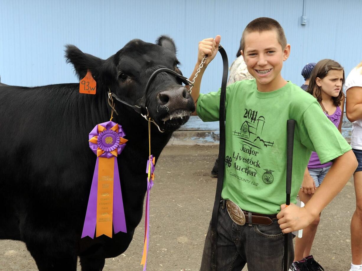 Columbian files
Bill Martin holds grand champion Joseph as he waits for his turn at the junior livestock auction at the 2011 Clark County Fair in Ridgefield.