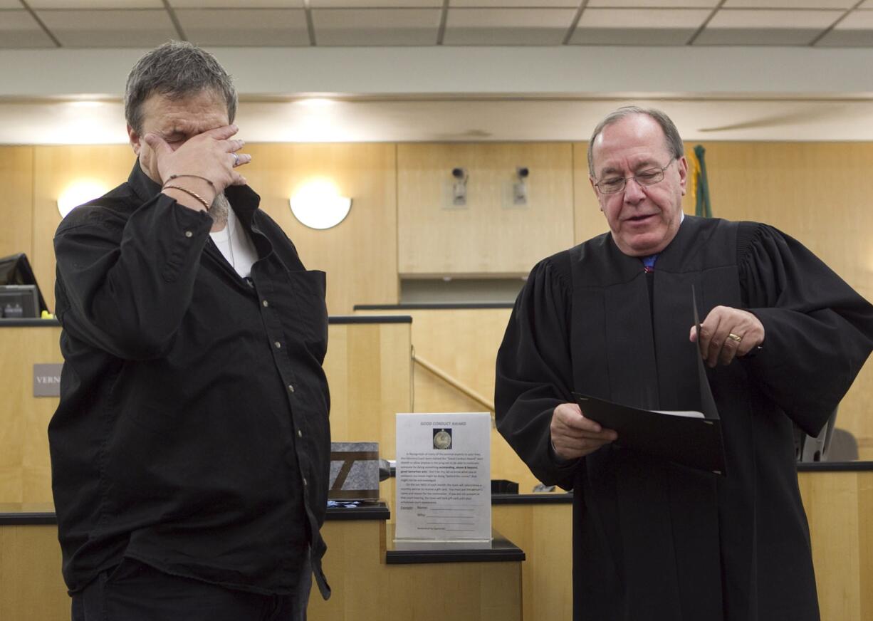 Jan &quot;Jay&quot; Couch, who served in the U.S. Navy, accepts a certificate from District Court Judge Vernon L.