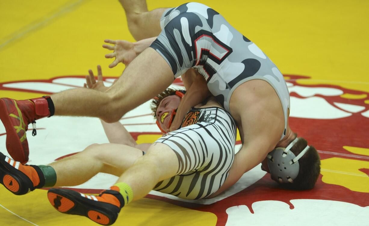 J.J. Talavera of Union, top, wrestles Robert Gomulkiewicz of Battleground in the 132 class at the Boys and Girls finals of the Clark County wrestling championships in Vancouver, WA., Saturday., Jan.