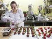 At Vancouver's Bleu Door Bakery, Kelly Conover devoted part of her Friday to preparing chocolate-covered strawberries.