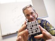 Thomas Gazzola holds a modified Rubik's cube his team decoded on their way to winning the Massachusetts Institute of Technology's Mystery Hunt 2015, considered to be one of the toughest challenges of its kind in the world.