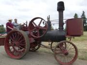 Lester Schurman, right, and Ben Scofield maneuver a 1910 Garscott 10 horsepower steam tractor through the grounds at the Rural Heritage Fair in Ridgefield in 2014.