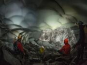 Cave explorers take a look around a chamber inside Mount St.