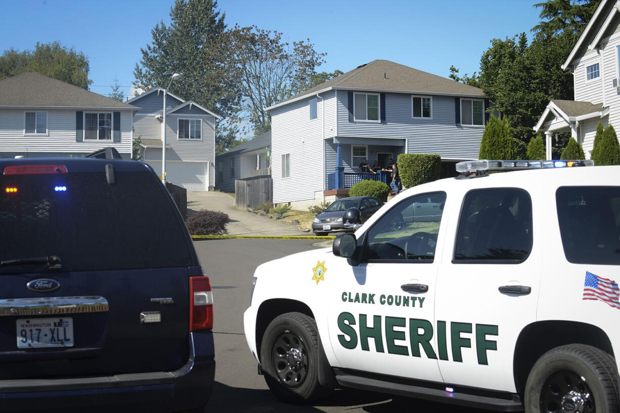 Clark County sheriff's deputies investigate at a home in Hazel Dell where three people were reportedly shot and killed on Tuesday July 14, 2015.