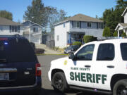 Clark County sheriff's deputies investigate at a home in Hazel Dell where three people were reportedly shot and killed on Tuesday July 14, 2015.