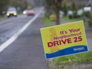 Yard signs reminding drivers to obey speed limits dot East Evergreen Boulevard, east of Harney Elementary School, in Vancouver.