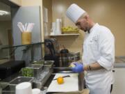 Executive chef Edward Helbig makes a fruit smoothie at the Terrace Caf? inside Legacy Salmon Creek Medical Center in Vancouver. The smoothies are part of a larger effort to offer healthier menu items.