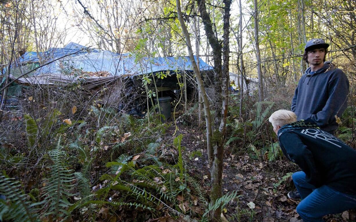 A walk through publicly owned woods in Northeast Hazel Dell brought concerned neighbors Allan Vander-Heyden and Terry Krause to a large network of tents and tarps.