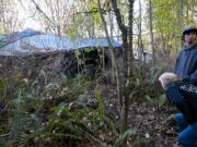 A walk through publicly owned woods in Northeast Hazel Dell brought concerned neighbors Allan Vander-Heyden and Terry Krause to a large network of tents and tarps.