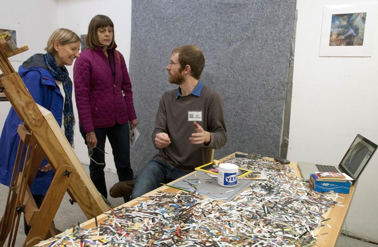 Artist Reid Trevarthen speaks with gallery visitors Kate Swavey, left, and Bonnie Waters on Sunday afternoon at the North Bank Artist Gallery in downtown Vancouver during the Clark County Open Studios Tour.