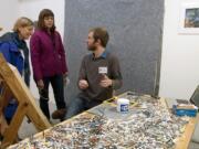 Artist Reid Trevarthen speaks with gallery visitors Kate Swavey, left, and Bonnie Waters on Sunday afternoon at the North Bank Artist Gallery in downtown Vancouver during the Clark County Open Studios Tour.