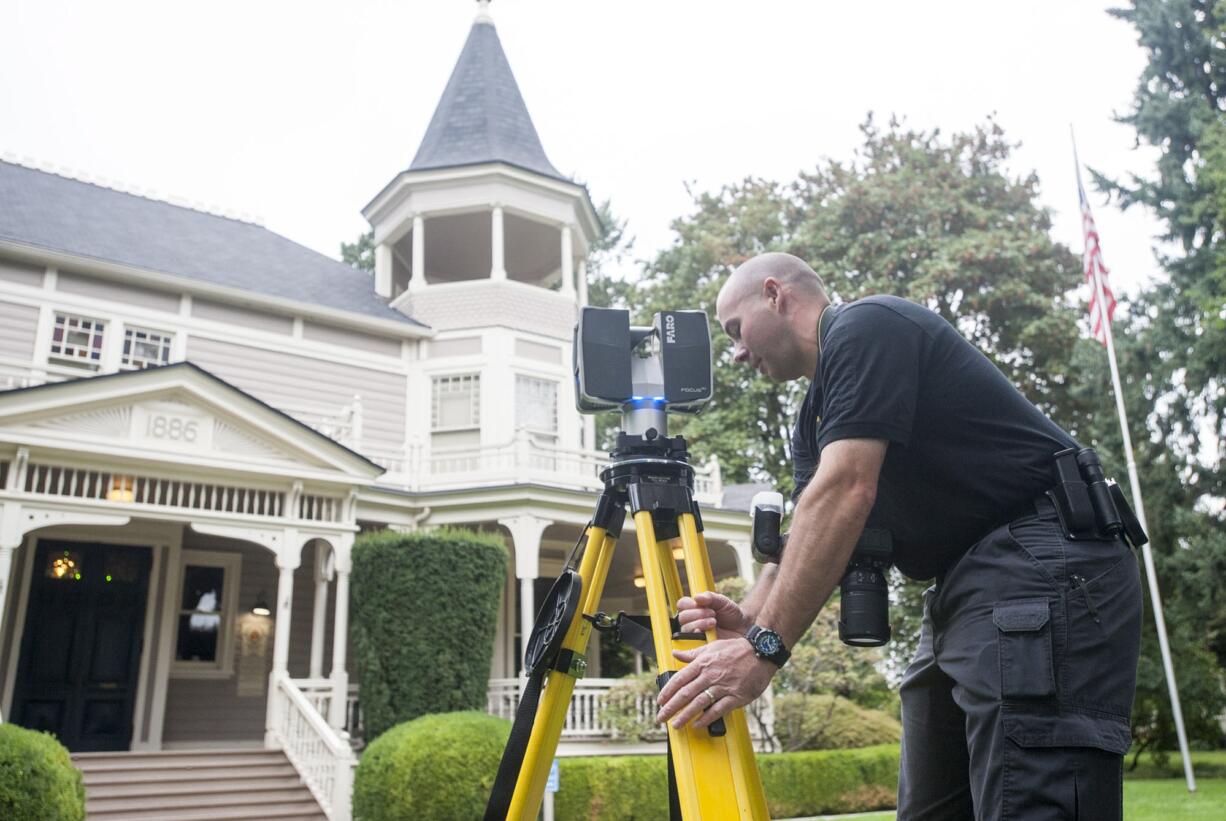 Clark County Sheriff's Office Detective Joe Swenson demonstrates how to use a 3-D imager, a device used to help investigators create an interactive photo of crime scenes.