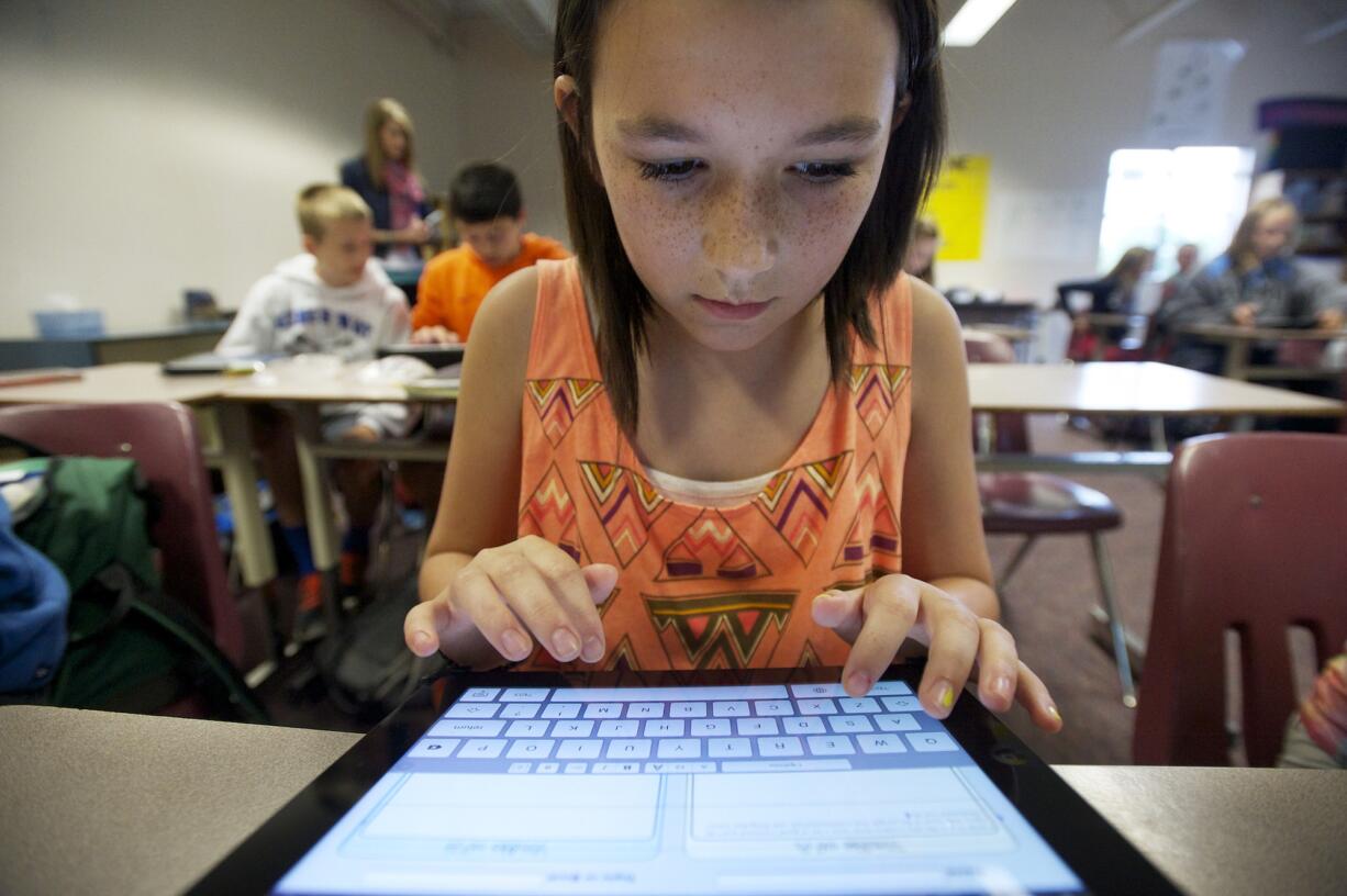 Photos by Steven Lane/The Columbian
Sydney Betterton, 11, a sixth grader in Carolyn Conners' class at Alki Middle School, says her iPad helps her contact her teacher and share homework assignments.