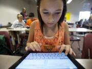 Photos by Steven Lane/The Columbian
Sydney Betterton, 11, a sixth grader in Carolyn Conners' class at Alki Middle School, says her iPad helps her contact her teacher and share homework assignments.